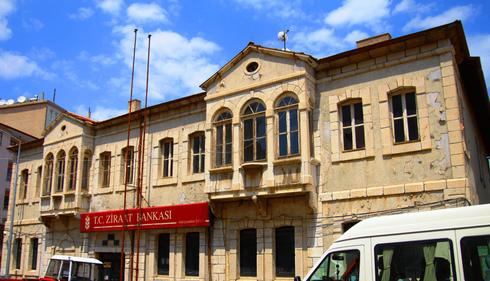 A two-storey historic bank building of marble and cut stone in the Ahisavi neighborhood of Akdağmadeni.